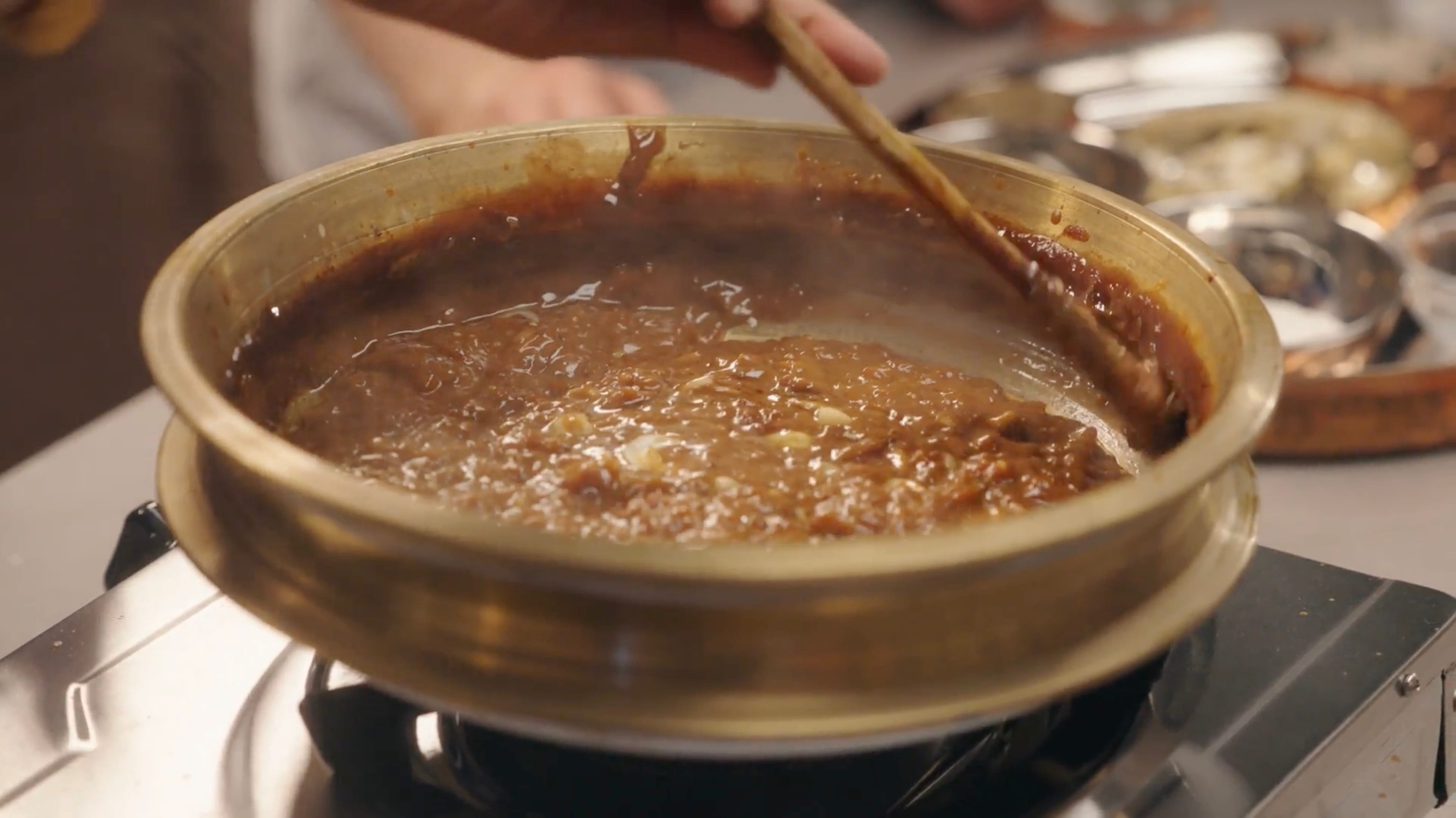 Chakka payasam being made in a traditional uruli pot